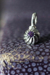 A delicate swirling gemstone charm – choose an Amethyst for your February birthday. 