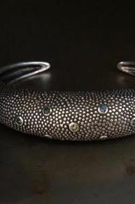 Close up of my Axolotl Cuff Bangle studded with 7 blue & green Tourmalines and embellished with a bobbled texture