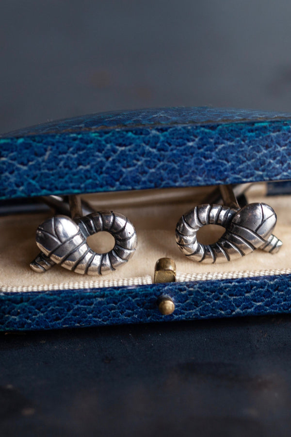 My Snake Cufflinks, inspired by Harry Potter's Slytherin Snake and Flobberworm, feature a neatly crossed curling snake