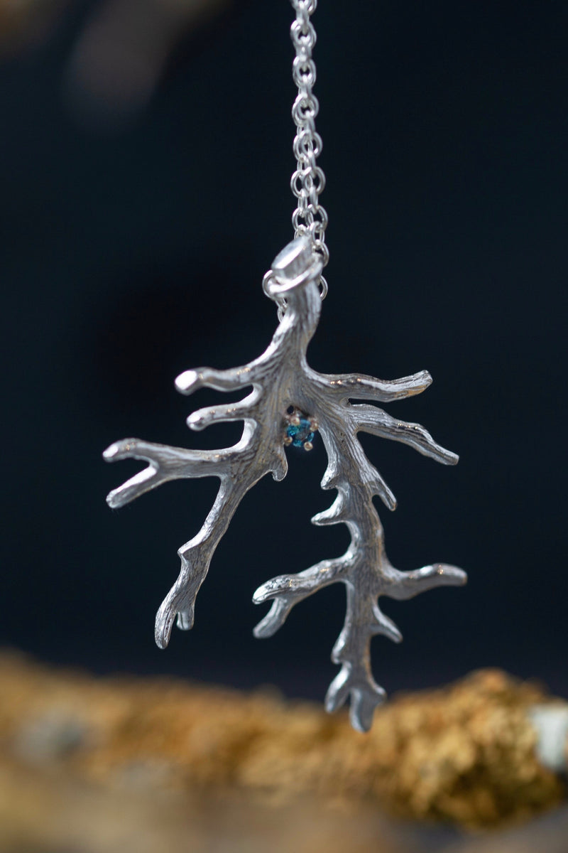 My branch pendant with a Swiss Blue Topaz November's birthstone, hangs from a delicate trace chain 