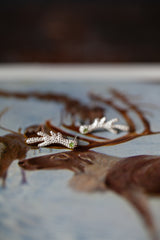 Small stud earrings inspired by the shape of antlers finished with a sparkling green peridot.