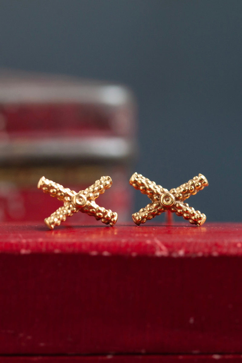 My Tiny Kiss Cross Studs are formed from a tiny cross or kiss.