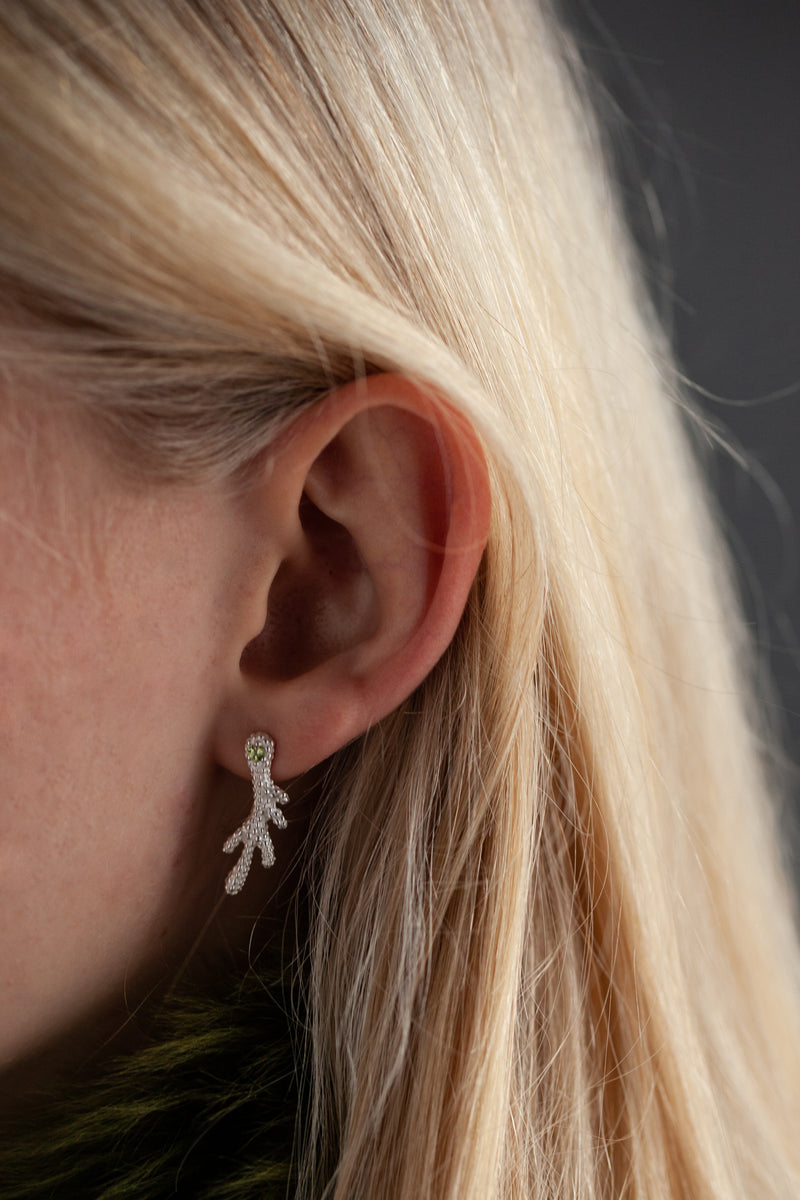 Small stud earrings inspired by the shape of antlers finished with a sparkling green peridot.