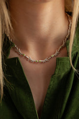 The links are made of small ‘antlers’ finished with my signature dotty texture and adorned with green peridots. 