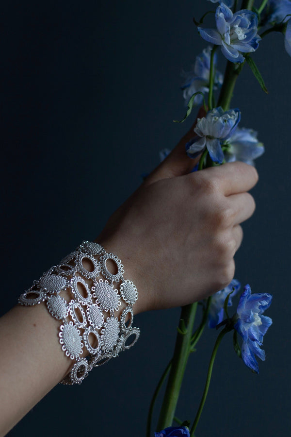 My Baroque Cuff Bracelet worn by a model, inspired by antique lace and ruffs, bring a timeless sense of drama