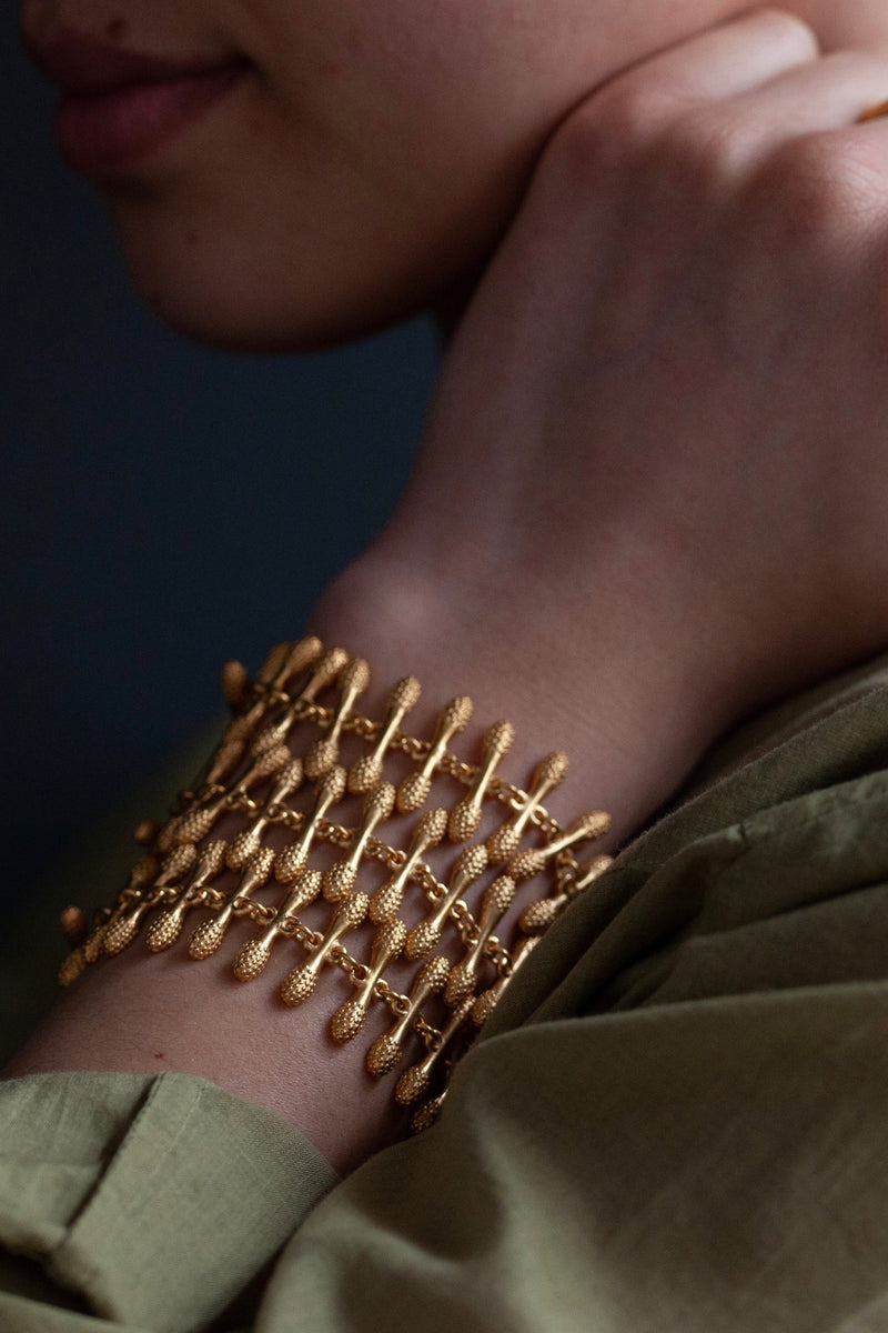 Model wearing my statement Spot the Matchstick Bracelet in gold plated silver with 3 rows of small bobbled bars