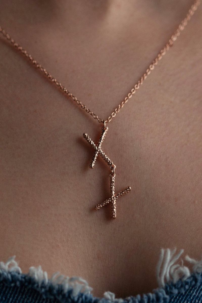 My Kiss Cross Pendant worn in rose gold plate is formed from a pair of linked crosses or kisses can be worn at two lengths