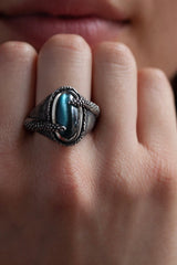 A unique ring worn by model handmade and hand-engraved Silver set with blue-green Cat’s Eye Tourmaline