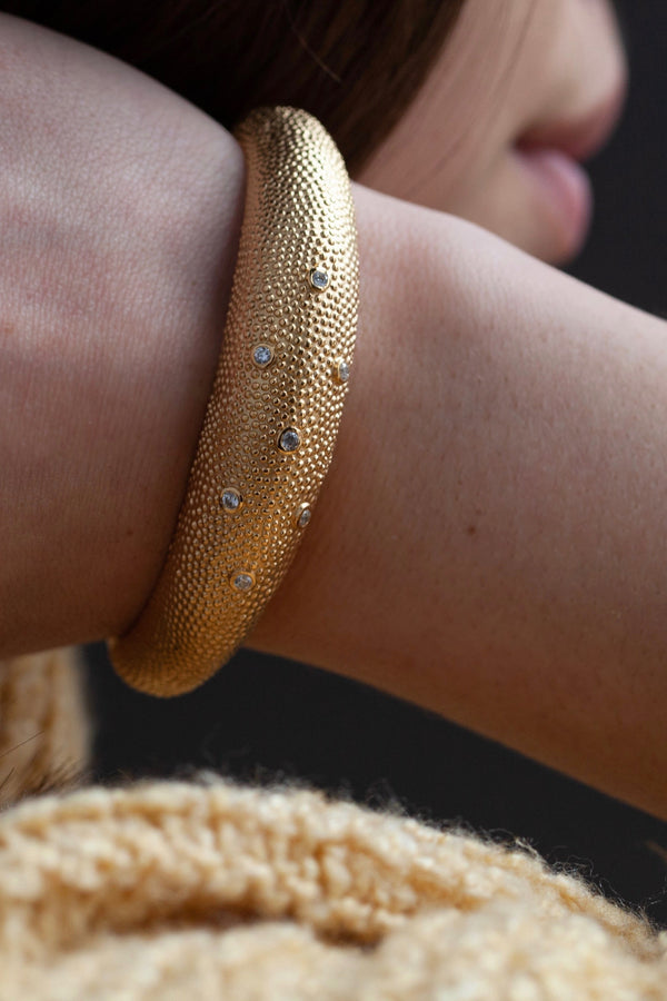 My Axolotl Cuff Bangle worn in gold plated silver with 7 cubic zirconia and by my signature bobbled texture