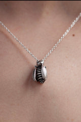My Tiny Bee necklace worn by a model features a chunky pendant on a fine chain with an extra bee's wing