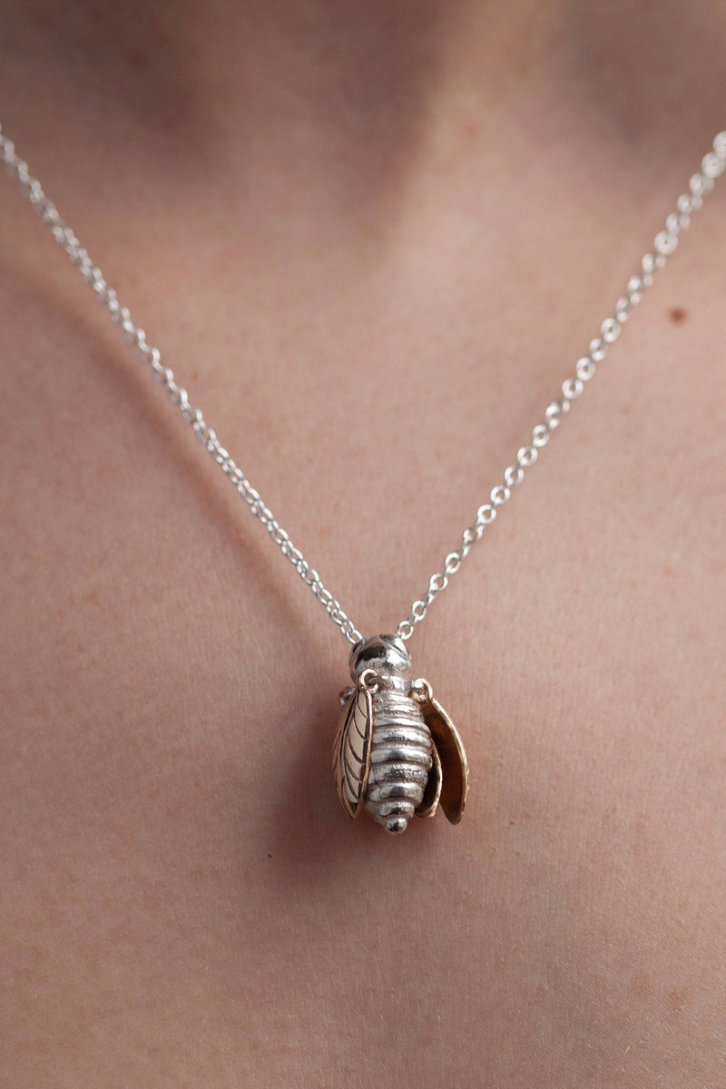 My Tiny Bee pendant worn by a model in silver with gold plated wings