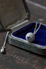 A special birthstone pendant for December in a jewellery box – its centrepiece is a tactile textured ball with a glistening Tanzanite at the base.