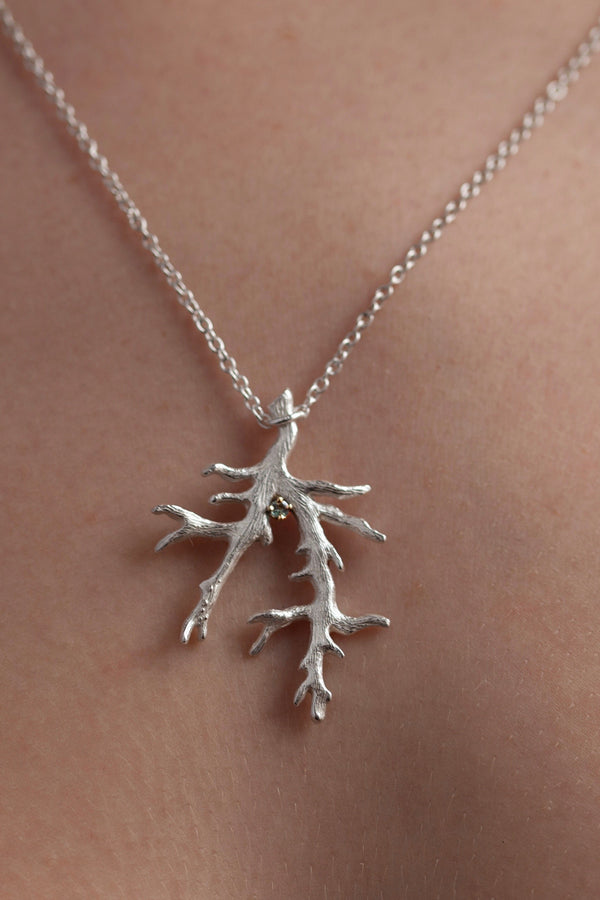 My unusual branch pendant worn by a model set with an Alexandrite June's birthstone, hangs from a delicate trace chain