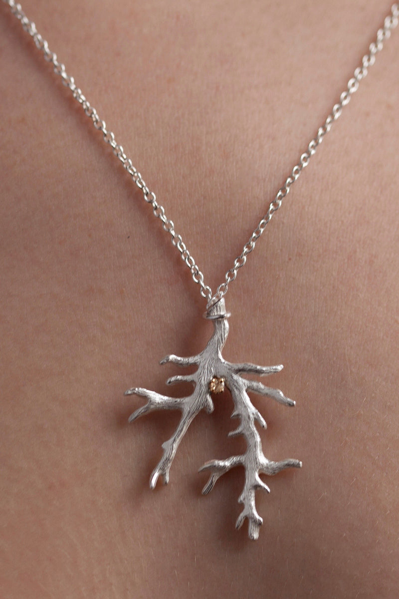 My branch pendant, with a Yellow Topaz November's birthstone, on a delicate trace chain worn by a model
