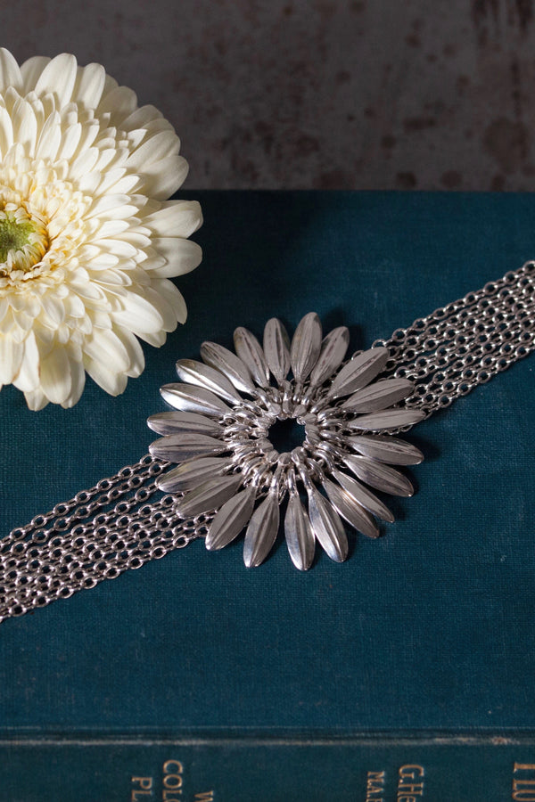 My Gerbera Bracelet in silver features a large stylised gerbera flower with movable petal charms 