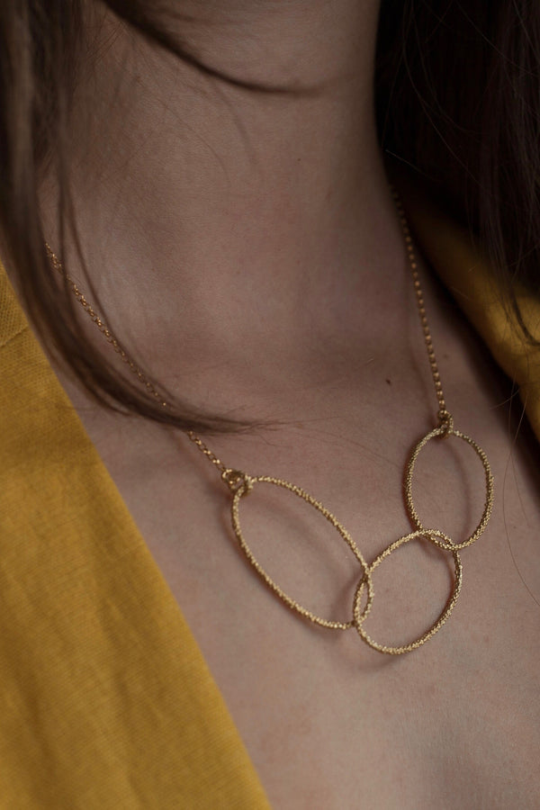 My Triple Oval Bobbled Hoop necklace worn by a model with 3 interlocking oval hoops on a belcher chain