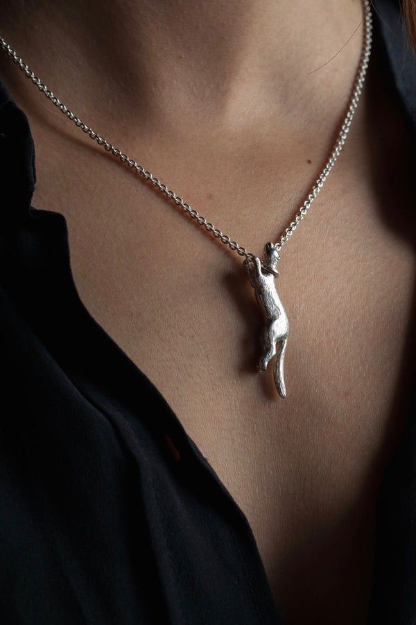 My Weasel pendant was inspired by a poem features a miniature silver weasel worn on a short trace chain