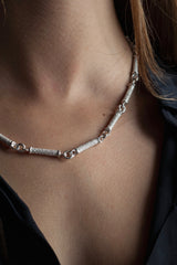 My Textured Link Necklace worn by a model is formed from textured silver bars joined with small silver hoops