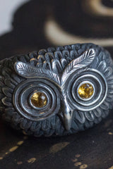 A statement Owl Ring in oxidised silver, inspired by Harry Potter's owl Hedwig, with Yelow Sapphire eyes