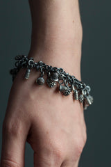 My Micro Pod Cluster Charm Bracelet in oxidised silver hangs with charms inspired by seed pods