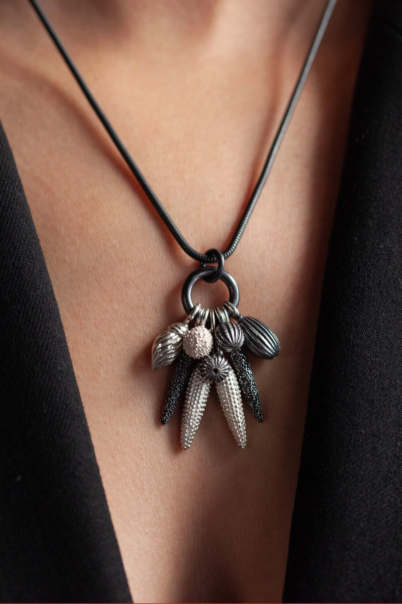 My Spot the Nine Pod Cluster Pendant worn on oxidised silver chain is hung with a bold charm pendant