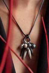 My Spot the Nine Pod Cluster Pendant necklace is hung with a bold charm pendant, inspired by seed pods