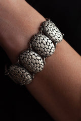 My ornate Turtle Shell Bracelet worn by model combines large patterned discs inspired by turtle shells