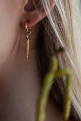 My Catkin Drop Earrings worn by a model feature a catkin-shaped charm 