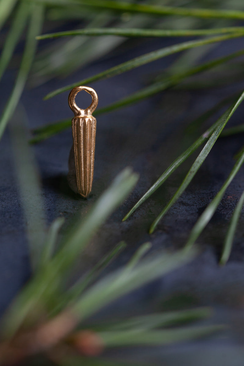 My Long Seed Pod Charm is an elegant striped charm inspired by the pointed seed pods of fennel