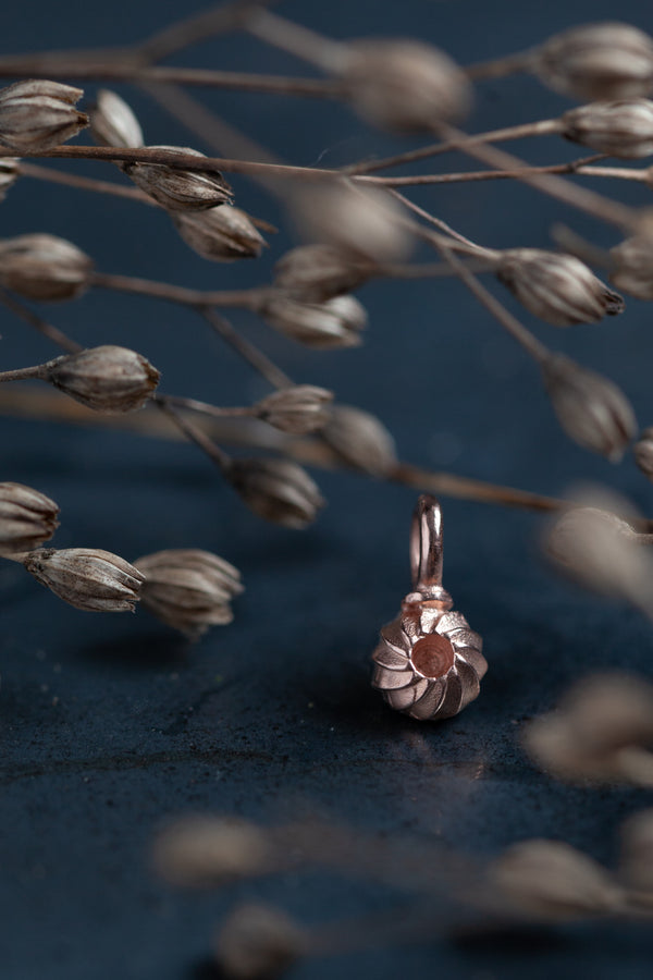 My Swirling Sepal Charm is a dainty round charm with an unusual central recess 