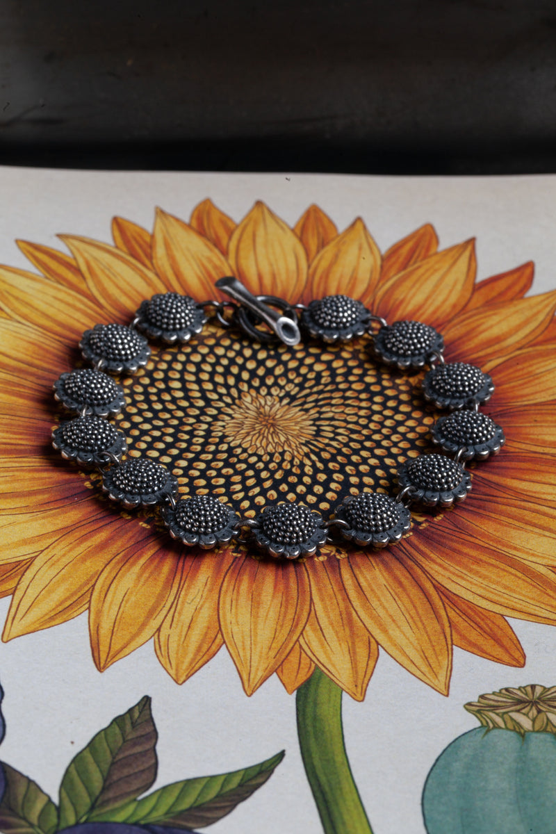 My Sunflower Bracelet features 13 delicate double sided sunflower heads side-by-side in ‘daisy’ chain 