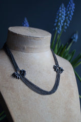 My Rice Pearl Necklace in oxidised silver features multiple chains decorated with two flowers made from rice pearl beads