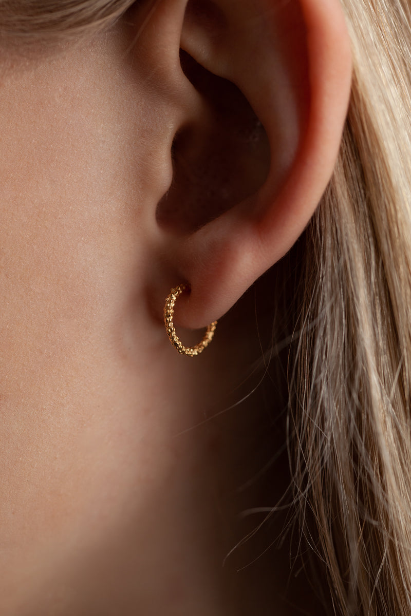 My Teeny Tiny Bobbled Hoops worn by a model in yellow gold plated silver
