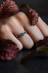 My geometric Ladder Ring has a slim band with simple striped detailing worn by model
