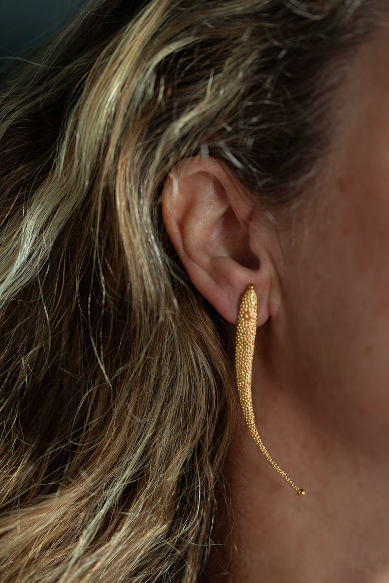 My Phish Drop Earrings worn by a model in yellow gold plated silver