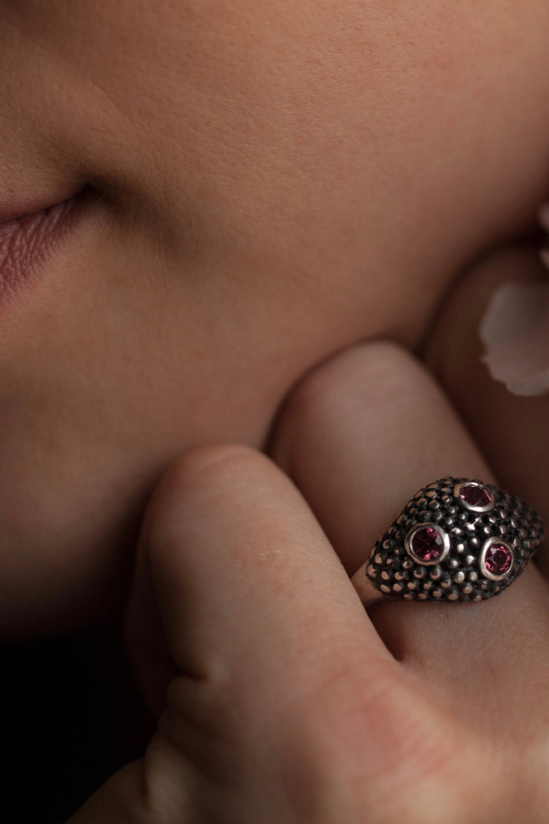 My Cobra Ring is worn by a model with beaded silver set with 3 pink garnets