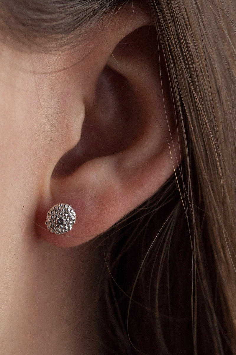 My Snake Eye Stud Earrings worn in silver feature a bobbled textured oval serpent's eye motif 