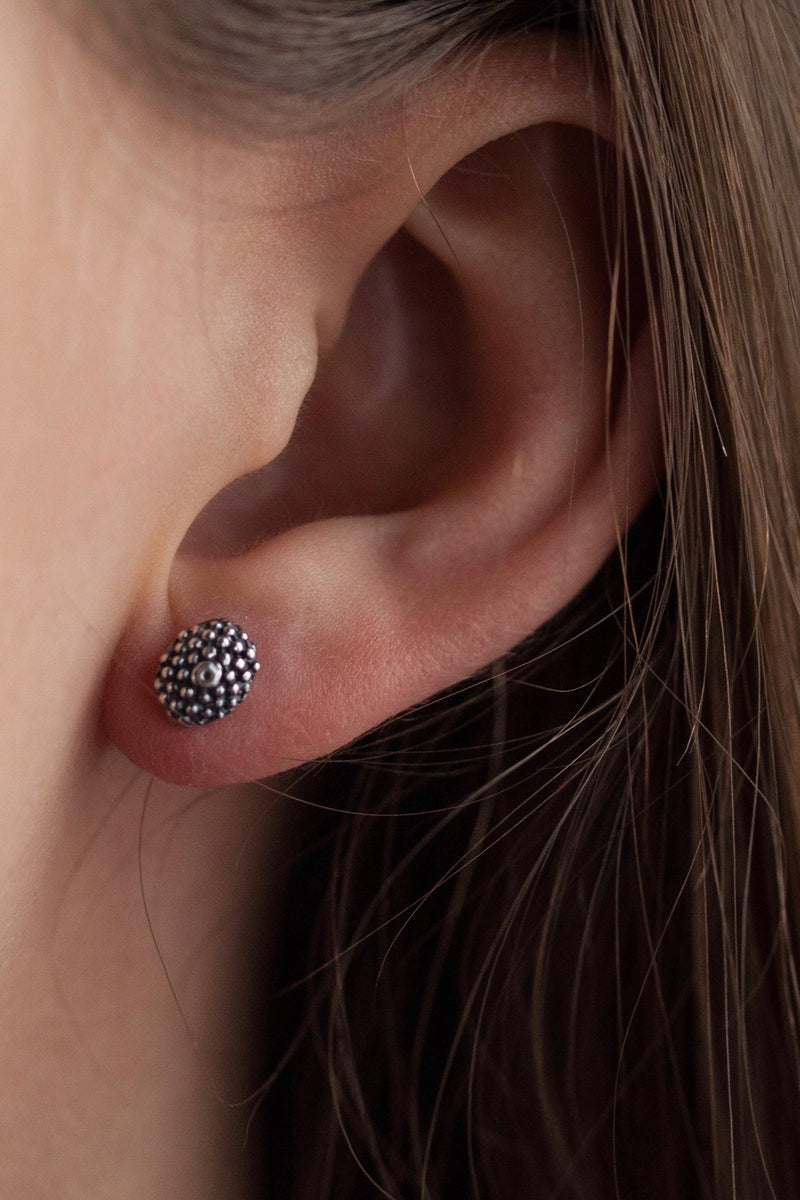 My Snake Eye Stud Earrings worn in oxidised silver feature a bobbled textured oval serpent's eye motif 