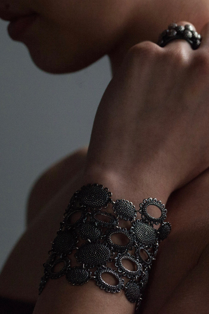 My Baroque Cuff Bracelet in oxidised silver worn by a model, inspired by antique lace and ruffs, bring a timeless sense of drama