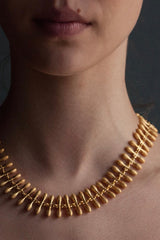 My Spot the Matchstick Necklace worn in gold plated silver formed from small linked 'matchstick' bars with a bobble texture