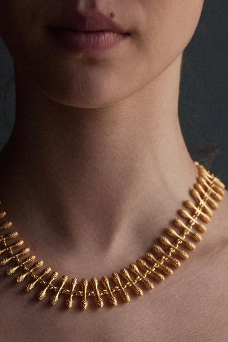 My Spot the Matchstick Necklace worn in gold plated silver formed from small linked 'matchstick' bars with a bobble texture