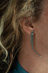 My Phish Earrings with Diamond Eyes worn by a model in oxididised silver