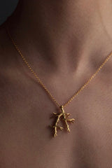 My Branch Pendant Necklace worn by a model in yellow gold plated silver, inspired by my love of trees, sits beautifully against the skin or clothing and makes the everyday a bit more special