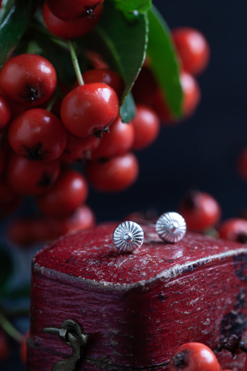 These small but intricately formed stud earrings are unusual and eye-catching. Their shape and texture was inspired by fungi.