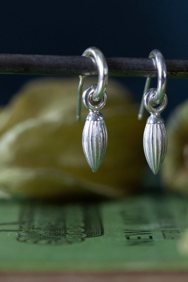 My Pointed Pod Drop Earrings are hung with a graceful striped charm