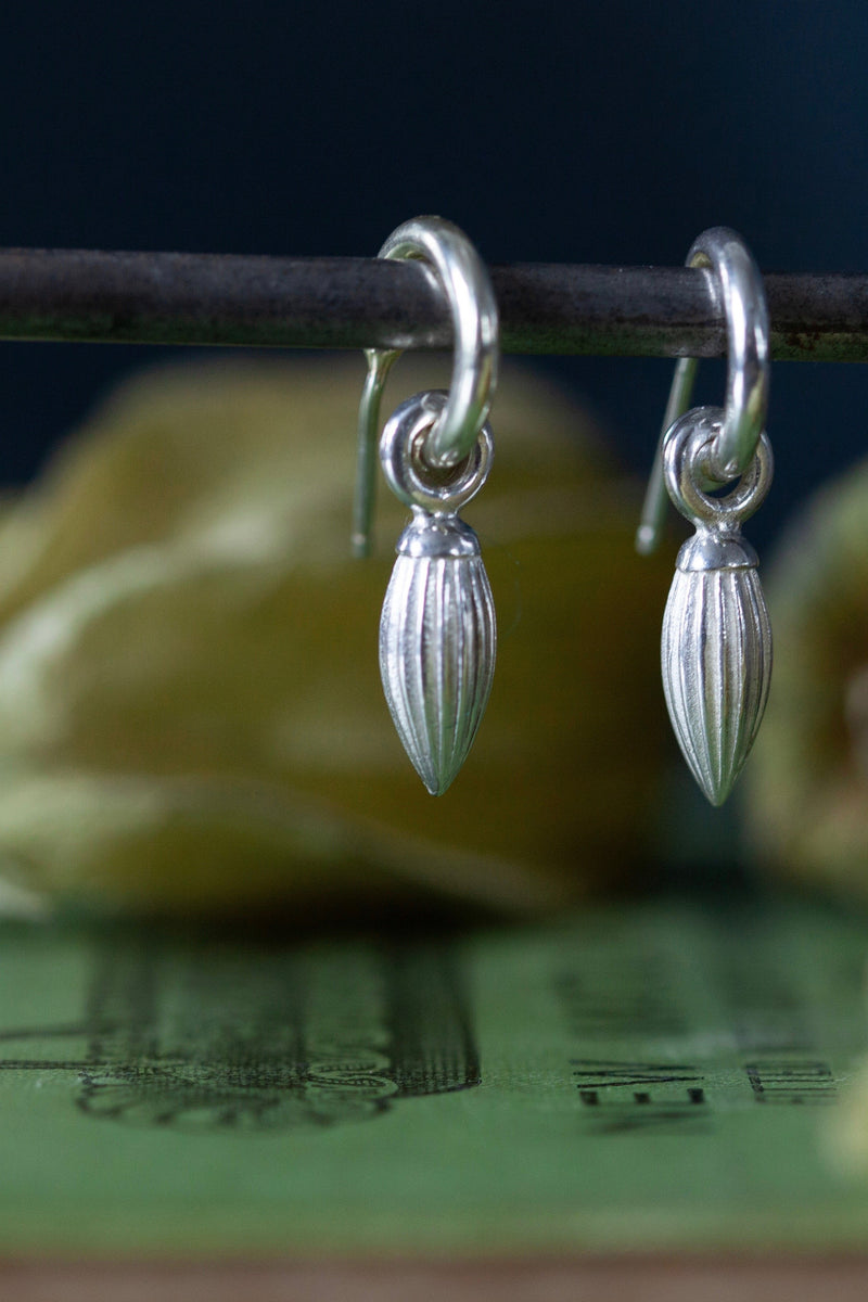 My Pointed Pod Drop Earrings are hung with a graceful striped charm