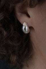 My Silver Cup Earrings worn in silver curve round under the earlobe and hang from a stud