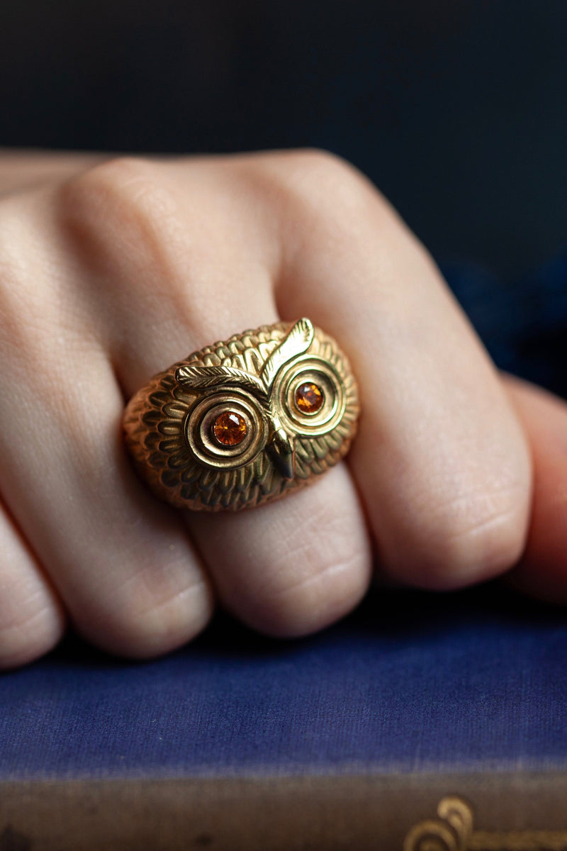 A statement Owl Ring worn in solid gold, inspired by Harry Potter's owl Hedwig, with Yelow Sapphire eyes
