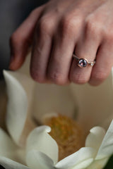 A one off Lilac Spinel in 18ct rose gold cup setting with a white diamond on 18ct white gold band 