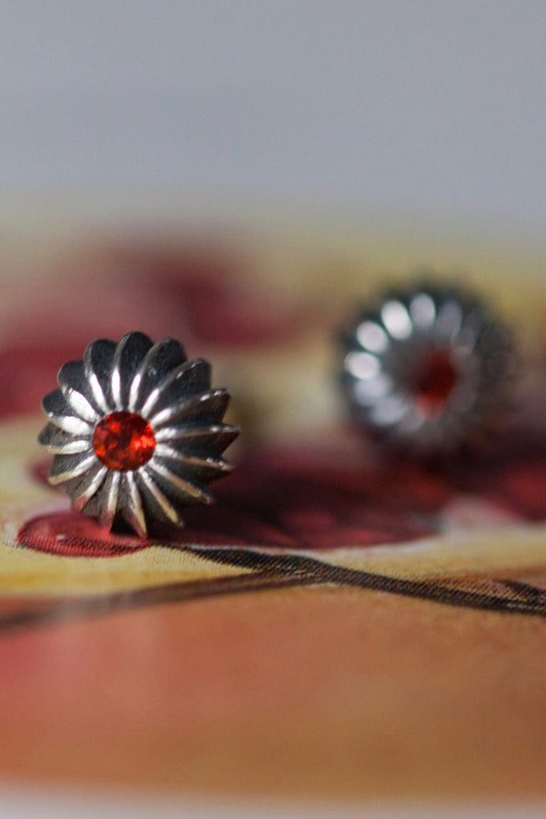 My January Red Garnet Birthstone Satsuma Studs are subtly striped and set with gemstones